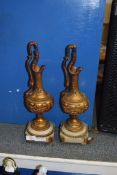 PAIR OF BRONZED METAL EWERS SET ON POLISHED ONYX STANDS