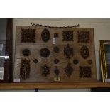 BOARD MOUNTED WITH A SELECTION OF VARIOUS CARVED FURNITURE DECORATION, THE BOARD 58CM WIDE