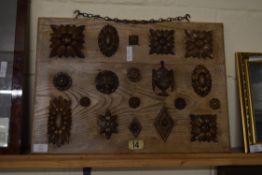 BOARD MOUNTED WITH A SELECTION OF VARIOUS CARVED FURNITURE DECORATION, THE BOARD 58CM WIDE