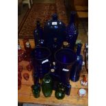 COLLECTION OF BLUE GLASS ITEMS TO INCLUDE CHEMISTS BOTTLES, NOVELTY WINE BOTTLES, VASES, GREEN GLASS