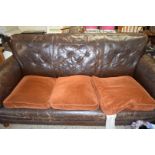 EARLY 20TH CENTURY BROWN LEATHER THREE-SEATER SOFA AND PAIR OF ACCOMPANYING CLUB STYLE CHAIRS,