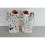 PAIR OF STAFFORDSHIRE VASES FORMED AS FIGURES BY TREE TRUNKS