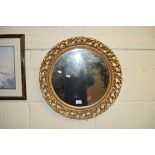 20TH CENTURY CIRCULAR GILT FRAMED WALL MIRROR, FRAME WITH FOLIATE DECORATION, 53CM DIAM