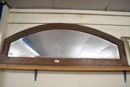 OAK FRAMED ARCHED OVERMANTEL MIRROR DECORATED WITH CARVED DETAIL