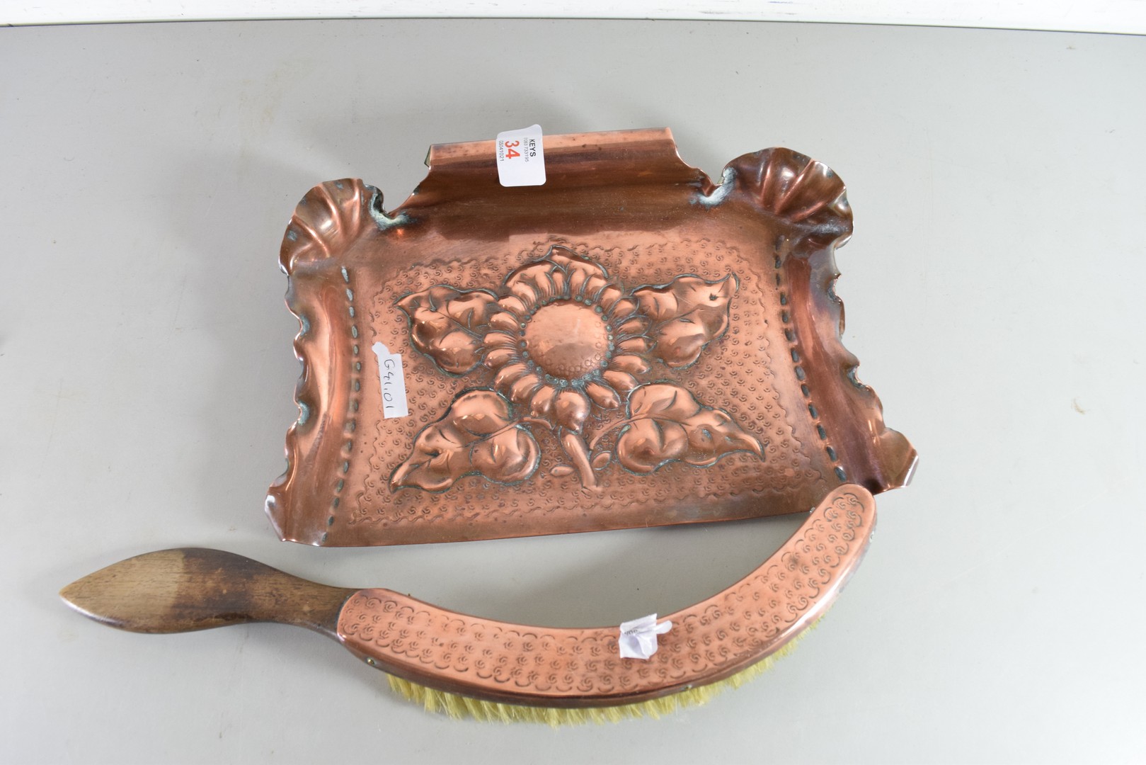 ARTS & CRAFTS COPPER CRUMB TRAY DECORATED WITH CENTRAL FLOWER AND ACCOMPANYING BRUSH