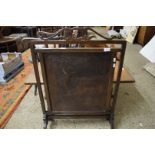 EARLY 20TH CENTURY OAK FRAMED FIRE SCREEN WITH PRESSED LEATHER CENTRAL PANEL DEPICTING MYTHICAL