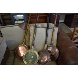 FOUR COPPER AND BRASS BED WARMING PANS ON TURNED WOODEN HANDLES