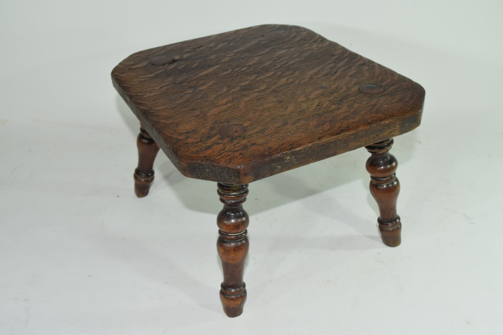 Late 19th century oak four legged milking stool