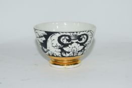 Small bowl decorated in black and white with a design by Fornisetti,