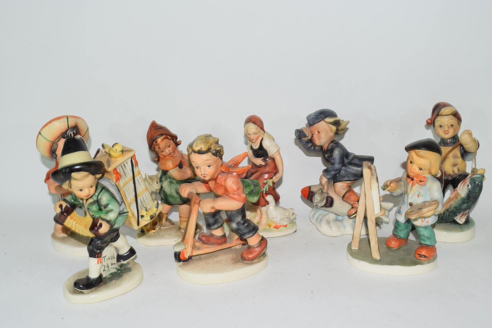 Collection of eight Friedel of Bavaria models of children doing various activities including one