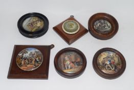 Group of pot lids on wooden mounts