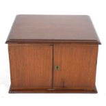 Late 19th/early 20th century hardwood table top cabinet with two doors opening to an interior with