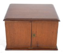 Late 19th/early 20th century hardwood table top cabinet with two doors opening to an interior with