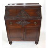 Late 19th/Early 20th century mahogany bureau with full front decorated with carved floral detail