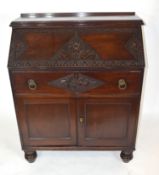 Late 19th/Early 20th century mahogany bureau with full front decorated with carved floral detail