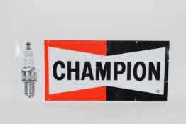 Two metal signs advertising Champion spark plugs