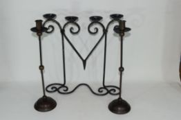 20th century iron four-light candelabra together with a pair of candlesticks (3) Condition: Good