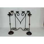 20th century iron four-light candelabra together with a pair of candlesticks (3) Condition: Good