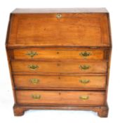 George III faded mahogany bureau with fall front opening to a shelved interior over four long