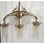 Early 20th century bronze framed four light centre ceiling light fitting, the frame modelled with