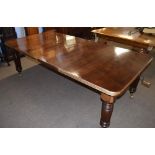 Late Victorian mahogany extending dining table raised on fluted legs and brass casters, 237cm wide