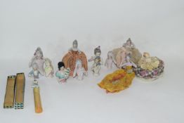 A collection of various continental porcelain pin cushion dolls to include examples in dress, a