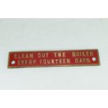 Small cast brass plaque marked "Clean out the boiler every 14 days"