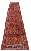 Large red ground Persian Kashan Runner, with all-over floral pattern 397cm x 93cm approximately No