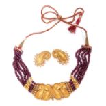 Indian Necklace, a design featuring four articulated textured leaf scroll panels having beaded edges