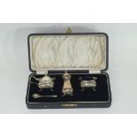 Cased three piece silver condiment set comprising a hinged lidded mustard and liner, open salt and