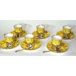 Set of six Royal Worcester coffee cans and saucers, the coffee cans in silver holders with Griffin