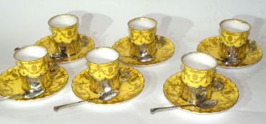 Set of six Royal Worcester coffee cans and saucers, the coffee cans in silver holders with Griffin