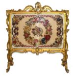 Large gilt gesso framed fire screen, the frame with elaborate foliate and scrolled detail, the