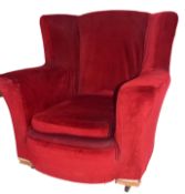 Early 20th century armchair, red upholstery with loose seat cushion, set on casters, 83cm high