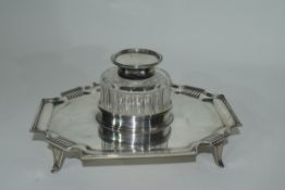 Late Victorian silver ink stand of shaped rectangular form resting on four splayed feet with