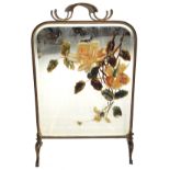 Early 20th century brass framed fire screen with central bevelled mirror with overpainted rose