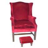 20th century wing back armchair in the Georgian style, upholstered in red fabric, with hardwood