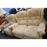 FLORAL UPHOLSTERED TWO-SEATER SOFA AND MATCHING ARMCHAIR