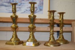 TWO PAIRS OF ANTIQUE BRASS CANDLESTICKS
