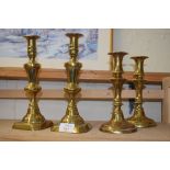 TWO PAIRS OF ANTIQUE BRASS CANDLESTICKS