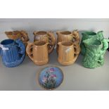 COLLECTION OF EIGHT SILVAC JUGS WITH SQUIRREL FORMED HANDLES