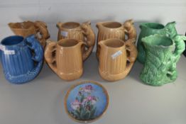 COLLECTION OF EIGHT SILVAC JUGS WITH SQUIRREL FORMED HANDLES