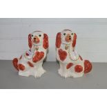 PAIR OF STAFFORDSHIRE STYLE SPANIELS DECORATED IN LIVER AND WHITE