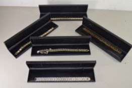 FIVE CASED MODERN GOLD PLATED AND STEEL BRACELETS