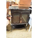 LATE VICTORIAN EBONISED SIDE CABINET, WITH TWO GLAZED DOORS OVER A SHELF RAISED ON CABRIOLE LEGS,