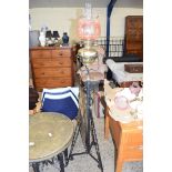 LATE 19TH/EARLY 20TH CENTURY OIL LAMP WITH COLOURED GLASS SHADE, BRASS FONT AND RAISED ON AN