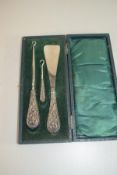 CASED SET OF SHOE HORN AND TWO BUTTON HOOKS WITH SILVER HANDLES