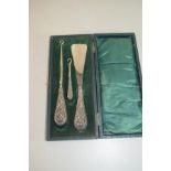 CASED SET OF SHOE HORN AND TWO BUTTON HOOKS WITH SILVER HANDLES