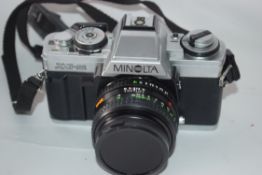 Minolta XG-M film camera together with Rokkor 50mm lens