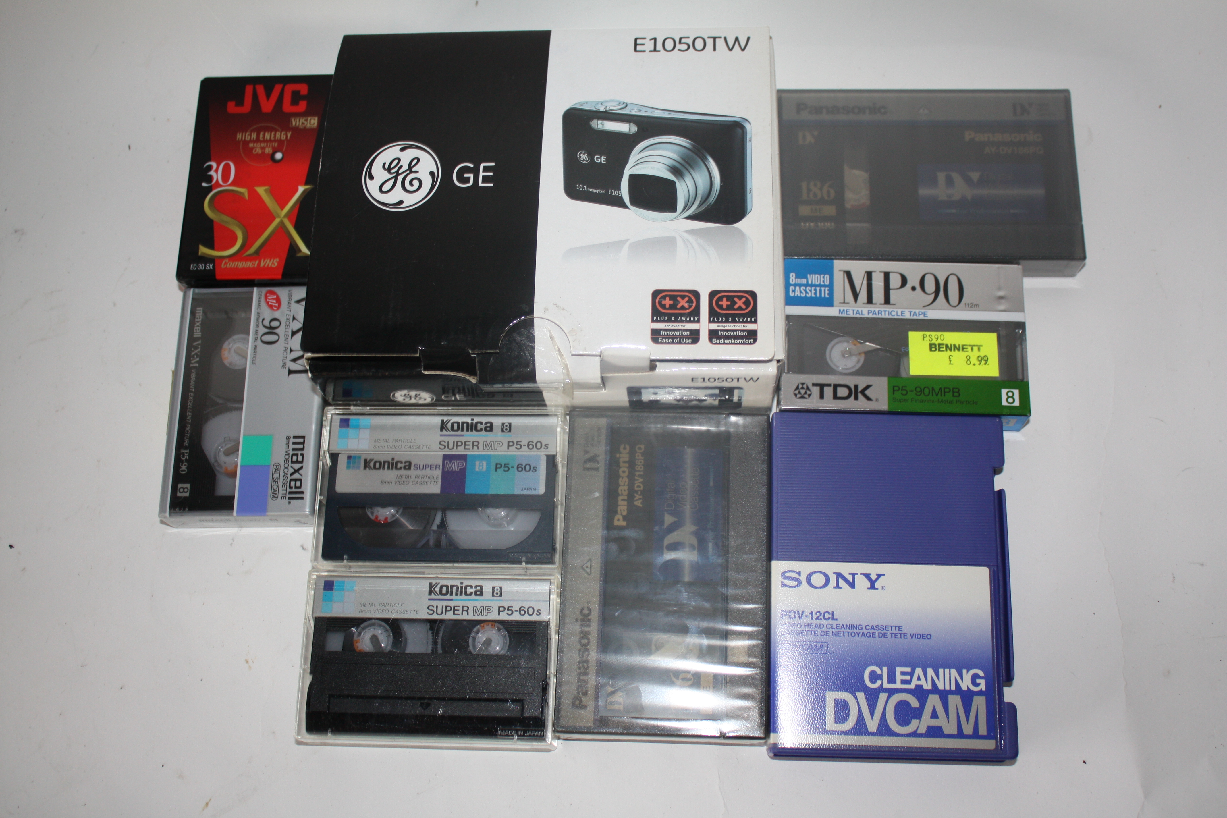 Multiple digital video cassettes, together with a GE E1050 TW camera